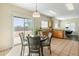 Bright breakfast nook with modern pendant lighting and sliding glass door to backyard at 16219 W Woodlands Ave, Goodyear, AZ 85338