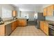 Traditional-style kitchen with granite counters, stainless appliances, and tile flooring at 16219 W Woodlands Ave, Goodyear, AZ 85338