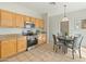 Clean kitchen featuring wood cabinets, stainless steel appliances, tile flooring and lots of natural light at 16219 W Woodlands Ave, Goodyear, AZ 85338