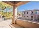 Balcony overlooking lush trees and neighborhood buildings, offering serene outdoor living space with railings at 16420 N Thompson Peak Pkwy # 2120, Scottsdale, AZ 85260