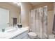 Bathroom featuring a single sink with white cabinets, a large mirror, and a shower with a patterned curtain at 16420 N Thompson Peak Pkwy # 2120, Scottsdale, AZ 85260