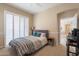 Cozy bedroom with white plantation shutters, neutral walls, gray headboard with blue pillows, and carpet flooring at 16420 N Thompson Peak Pkwy # 2120, Scottsdale, AZ 85260