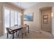 Bright dining room with modern table, stylish chairs, contemporary light fixture, and shuttered windows at 16420 N Thompson Peak Pkwy # 2120, Scottsdale, AZ 85260