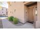 Welcoming front entrance showcasing a neutral facade, manicured bushes, and a charming, well-lit doorway at 16420 N Thompson Peak Pkwy # 2120, Scottsdale, AZ 85260