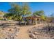 Inviting outdoor gazebo with stone pathway and desert landscaping at 16420 N Thompson Peak Pkwy # 2120, Scottsdale, AZ 85260