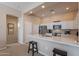 Well-lit kitchen featuring stainless steel appliances, white cabinetry, quartz countertops, and a breakfast bar at 16420 N Thompson Peak Pkwy # 2120, Scottsdale, AZ 85260