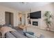 Comfortable living room featuring a fireplace with TV, neutral tones, and an open, airy layout at 16420 N Thompson Peak Pkwy # 2120, Scottsdale, AZ 85260