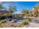 Scenic pond with rocky accents and lush landscaping, creating a tranquil outdoor oasis within a well-maintained community at 16420 N Thompson Peak Pkwy # 2120, Scottsdale, AZ 85260