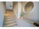 Carpeted staircase featuring a modern mirror and decorative cactus, creating an inviting and stylish transition between floors at 16420 N Thompson Peak Pkwy # 2120, Scottsdale, AZ 85260