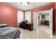 Bright bedroom featuring tiled flooring, a desk, and ensuite bathroom at 16528 W Pierce St, Goodyear, AZ 85338