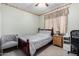 Cozy bedroom with a wooden bed frame, ceiling fan, and decorative accents at 16528 W Pierce St, Goodyear, AZ 85338