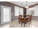 Elegant dining room with classic wood table and chairs, complemented by natural light at 16528 W Pierce St, Goodyear, AZ 85338