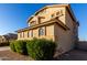 Close-up of the side of the two-story stucco home showing the landscaping and architectural details at 16528 W Pierce St, Goodyear, AZ 85338