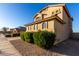 Side view of a two-story home with a well-manicured yard and architectural details at 16528 W Pierce St, Goodyear, AZ 85338