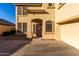 Close up of a home's front entrance, featuring a screen door and well-kept landscaping at 16528 W Pierce St, Goodyear, AZ 85338