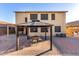 Outdoor gazebo with dining set in brick paved backyard, shaded home exterior in the background at 16528 W Pierce St, Goodyear, AZ 85338