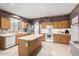 Bright kitchen featuring an island, stainless steel appliances, and wood cabinets at 16528 W Pierce St, Goodyear, AZ 85338