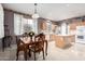 Open kitchen with stainless steel appliances, an island, and an adjacent dining area at 16528 W Pierce St, Goodyear, AZ 85338