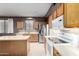 Well-lit kitchen featuring stainless steel appliances, wood cabinets, and ample countertop space at 16528 W Pierce St, Goodyear, AZ 85338