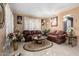 Comfortable living room with stylish decor, leather sofas, and bright tile flooring at 16528 W Pierce St, Goodyear, AZ 85338