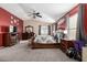 Spacious main bedroom with a decorative bedframe, dresser, and carpeted floors at 16528 W Pierce St, Goodyear, AZ 85338