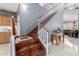 Staircase with wood treads and white railings, with view of entryway at 16528 W Pierce St, Goodyear, AZ 85338