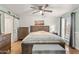 Bedroom featuring hardwood floors, a ceiling fan, soft, neutral colors, and a large bed at 17217 E Calaveras Ave, Fountain Hills, AZ 85268