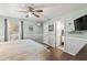 Bedroom with green walls, hardwood floors, a ceiling fan, and a door leading to the Primary bathroom at 17217 E Calaveras Ave, Fountain Hills, AZ 85268