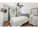 Bedroom featuring hardwood floors, a ceiling fan, and a bright window with gray curtains at 17217 E Calaveras Ave, Fountain Hills, AZ 85268