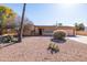 Charming single-story home features desert landscaping, a two-car garage, and an American flag at 17217 E Calaveras Ave, Fountain Hills, AZ 85268