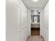 Hallway featuring multiple closets leading to a bedroom with hardwood flooring and a ceiling fan at 17217 E Calaveras Ave, Fountain Hills, AZ 85268