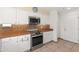 Kitchen features stainless appliances, white cabinets and tiled backsplash and flooring at 17217 E Calaveras Ave, Fountain Hills, AZ 85268