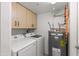 Bright laundry room features a modern washer and dryer set, with convenient upper cabinets at 17217 E Calaveras Ave, Fountain Hills, AZ 85268