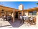 Inviting outdoor kitchen with covered dining, bar seating, built-in grill, and lush backyard views at 17217 E Calaveras Ave, Fountain Hills, AZ 85268