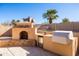 Outdoor kitchen featuring a built-in barbeque, bar seating, and desert landscaping at 17217 E Calaveras Ave, Fountain Hills, AZ 85268