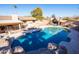 An inviting in-ground pool features rock accents and a shaded lounge area, perfect for relaxing and entertaining outdoors at 17217 E Calaveras Ave, Fountain Hills, AZ 85268