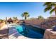 Sparkling pool with rock waterfall feature, tropical landscaping, and ample sunshine at 17217 E Calaveras Ave, Fountain Hills, AZ 85268