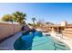 Sparkling pool with rock waterfall feature, tropical landscaping, and ample sunshine at 17217 E Calaveras Ave, Fountain Hills, AZ 85268