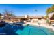 Sparkling pool with rock waterfall feature, tropical landscaping, and covered patio at 17217 E Calaveras Ave, Fountain Hills, AZ 85268