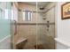 Bathroom shower featuring tile walls, bench, shower head, and glass door at 17217 E Calaveras Ave, Fountain Hills, AZ 85268