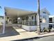 Inviting manufactured home featuring a covered carport and front porch with white railings at 177 S Limestone Dr, Apache Junction, AZ 85119