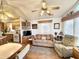 Cozy living room with ceiling fan, wood accents, large windows, and comfortable furniture arrangement at 177 S Limestone Dr, Apache Junction, AZ 85119