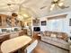 Inviting living space with a view of the kitchen, ceiling fan and cozy, patterned sofa at 177 S Limestone Dr, Apache Junction, AZ 85119