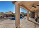 Covered patio overlooks a sparkling pool and spa, perfect for relaxing and entertaining outdoors at 17793 W Corrine Dr, Surprise, AZ 85388