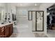 Light and bright bathroom featuring a soaking tub, separate shower, and white tile floors at 17793 W Corrine Dr, Surprise, AZ 85388