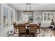 Dining room with a wooden table, seating for six, and natural light from shuttered windows at 17793 W Corrine Dr, Surprise, AZ 85388