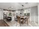 Open kitchen and dining area with stainless steel appliances, white cabinets, and a wooden dining table at 17793 W Corrine Dr, Surprise, AZ 85388