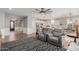 Bright, open-concept living room features a ceiling fan and flows into an eat-in kitchen at 17793 W Corrine Dr, Surprise, AZ 85388