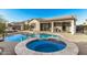 Backyard pool and spa with covered patio, offering a perfect blend of relaxation and entertainment space at 17793 W Corrine Dr, Surprise, AZ 85388