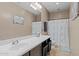 Well-lit bathroom featuring a single sink vanity, large mirror, and shower-tub combo at 18118 W Golden Ln, Waddell, AZ 85355